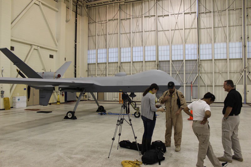 Cronkite Borderlands Initiative reporter Alex Lancial prepares for an interview with a Customs and Border Protection drone pilot at Naval Air Station Corpus Christi in Texas. Photo By Trahern W. Jones.