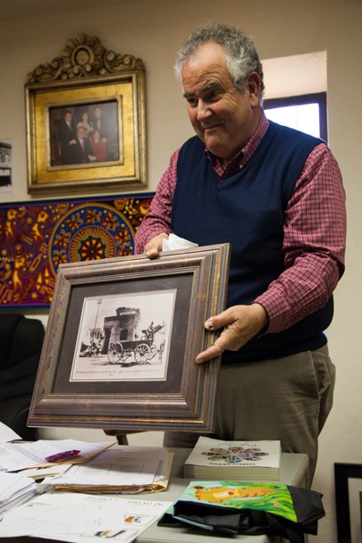 Gregory Kory shows off an old family photo as he tells the story of how the Kory's became business owners in Nogales, Ariz. Photo by Perla Farias.