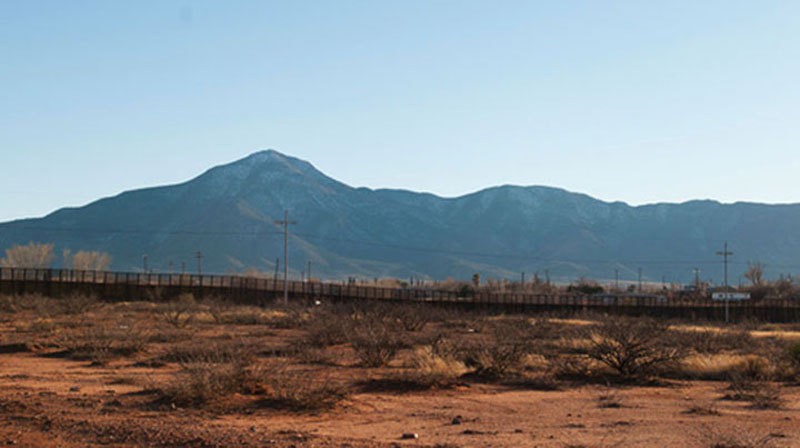 Dennis Moroney's ranch comes within 20 miles of the southern border fence of the U.S., near Naco, Ariz. Looking south into Mexico, Moroney can see the Sierra San Jose Mountains. Photo by Molly J. Smith.