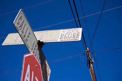 A street sign points to a dental office in Los Algodones, Mexico. The town is a medical tourism destination, but U.S. officials worry about the safety of prescription drugs and medical procedures obtained outside of the U.S. Photo by Lillian Reid.