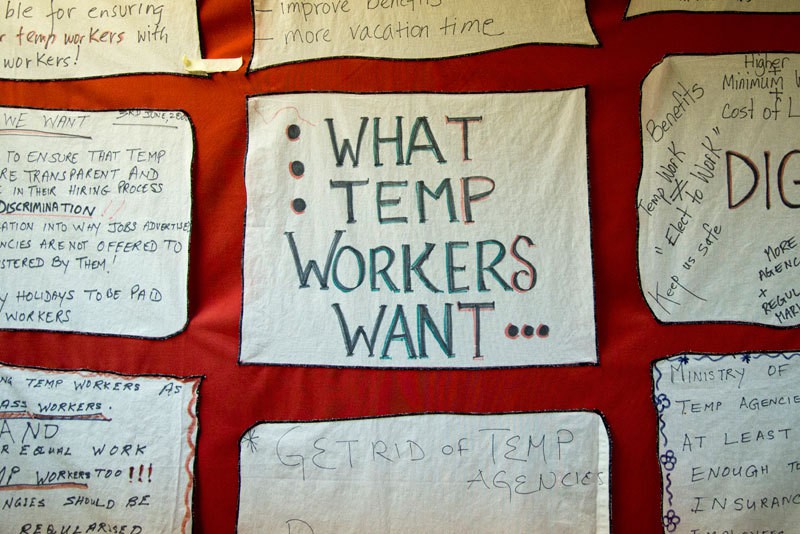 A hand-painted banner hangs in the Worker's Action Center in Toronto. Groups from the center advocate for better treatment of Canada's guest workers. Photo by Lillian Reid.