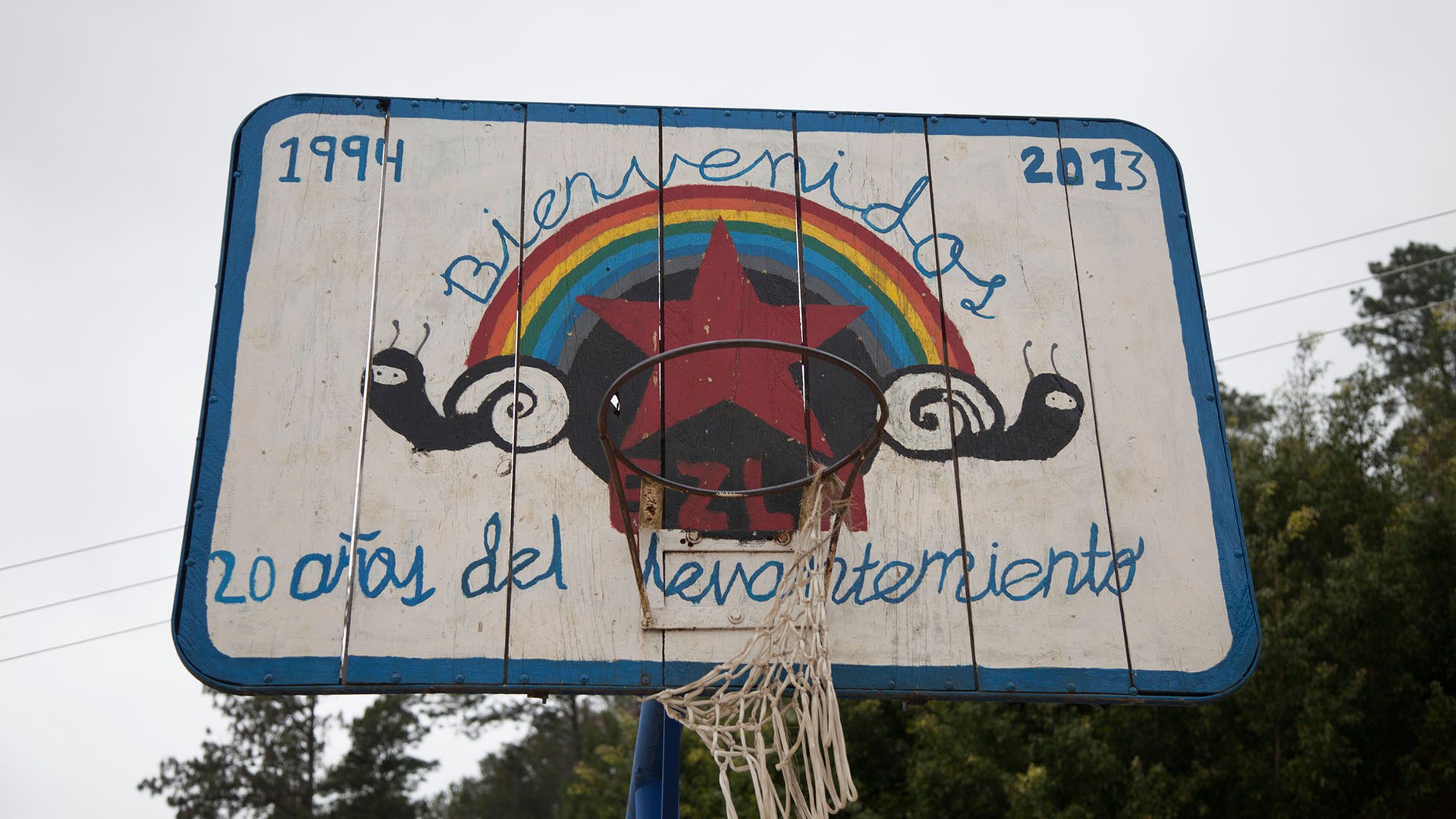 A basketball hoop in Caracol Morelia commemorates 20 years of Zapatista endurance. In 2013, the Zapatistas opened their communities to foreign visitors, inviting them in to learn about their way of life. (Photo by Rachel Leingang.)