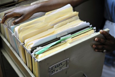 Violeta Bosico displays files from her case. The Inter-American Court of Human Rights ruled that the Dominican government violated basic human rights laws by denying Bosico a birth certificate.