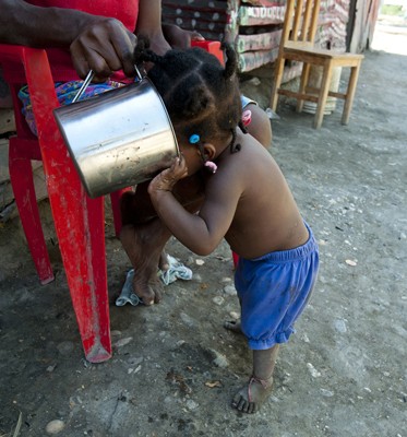 Batey 9 resident Osmila Torres, 2, drinks Coca-Cola. Her mother bought the Coca-Cola for 15 pesos, or about 40 cents, in order to soothe the child’s sore throat. By comparison, five gallons of purified water from the batey’s grocery store costs 35 pesos, or about 90 cents. 