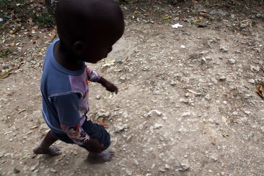 QueQue, 4, walks barefoot in the rocky roads of Batey San Isidro.