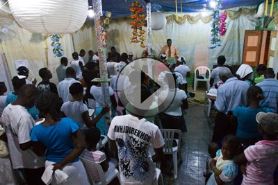 People listen to a sermon at Open Arms, a Haitian Protestant church in Comendador, Dominican Republic.