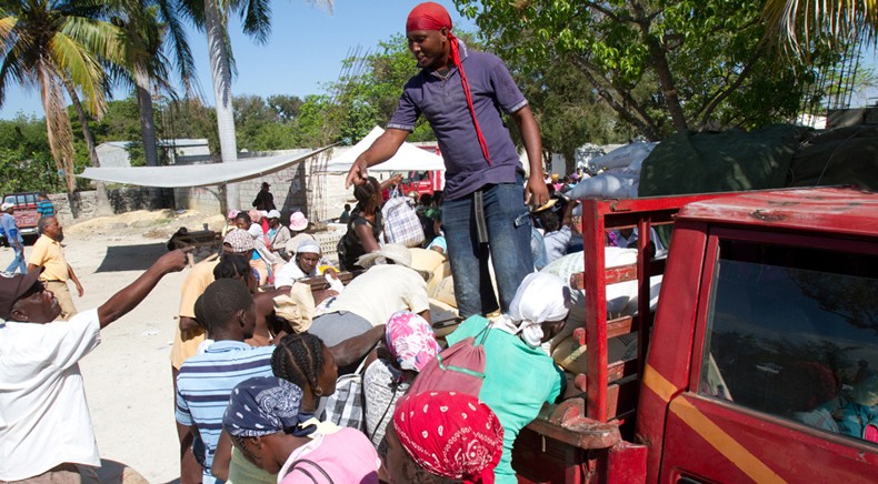 Haitians buy rice at a market set up in a dirt lot just a few yards from the border. 