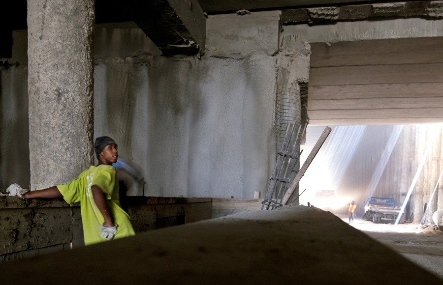 A construction worker looks into the distance while working on the subway in Santo Domingo, Dominican Republic. The subway’s labor force is almost entirely Haitian because they come at a cheaper price, former transportation minister Hamlet Hermann said.