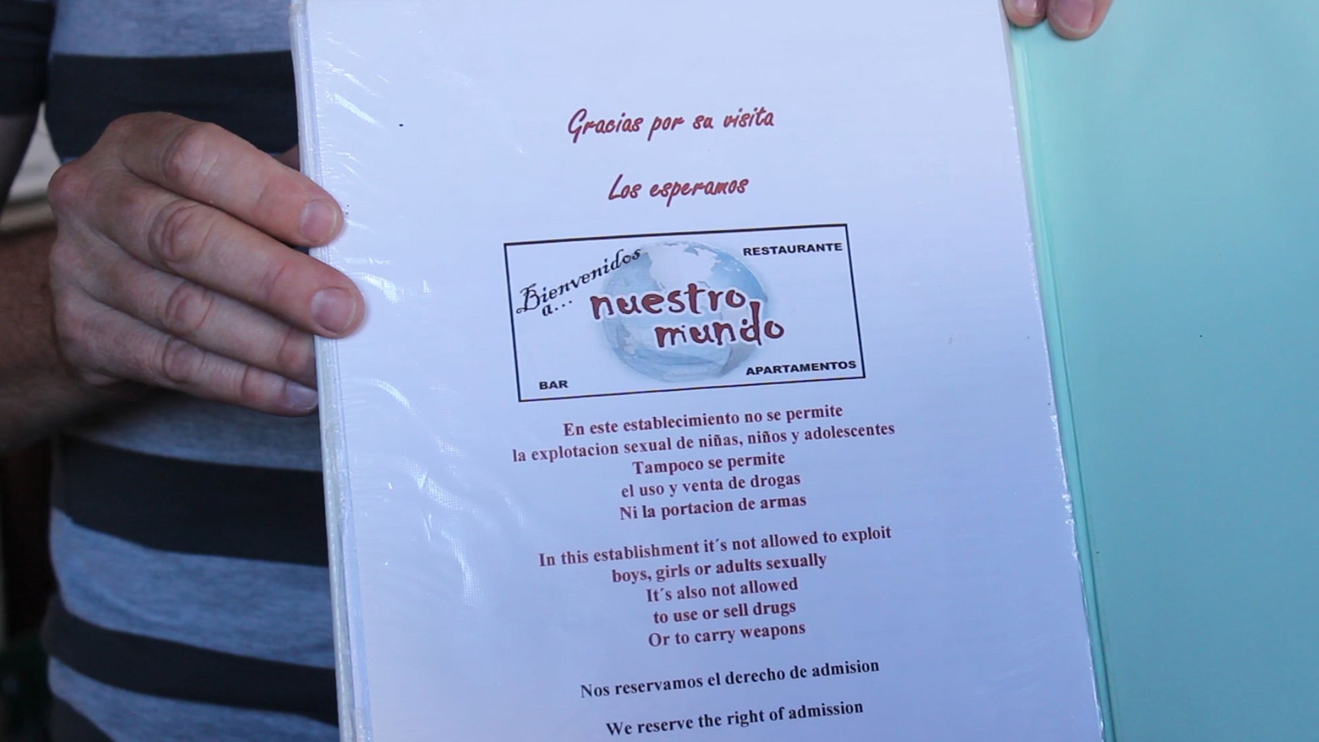Gerrit Rosbeek, owner of Nuestro Mundo, shows off the warning in his menu. He feels that it is the duty of the business owners in Granada to support the efforts of the police. Elizabeth Riecken (Photo by Elizabeth Riecken)