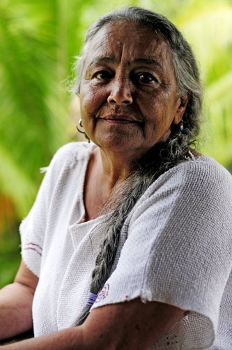 Naniki Reyes Oscario, a Taino Indian elder in Puerto Rico, poses for a portrait outside her home in the central mountains. Oscario said she is frustrated because despite cultural and historical recognition as an indigenous community, the Taino nation is not federally recognized by the governments of the United States and Puerto Rico. Photo by Brandon Quester