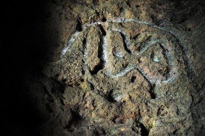 Hidden in a series of caves on the western shoreline of Puerto Rico, historic carvings like this one, mark the existence of the indigenous Taino Indians. Photo by Brandon Quester