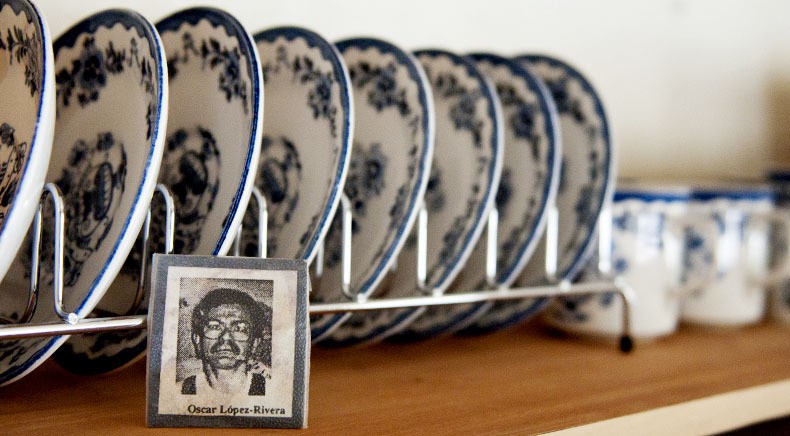 A photo of Oscar Lopez Rivera sits in front of china plates that he gave to his mother, Andrea Rivera. She vowed to never use the china until Rivera was freed from prison in the United States. When she died, the dishes passed to Oscar's sister and then his niece, Babbie Lugo. He was convicted of seditious conspiracy in 1981. Photo by Molly J. Smith