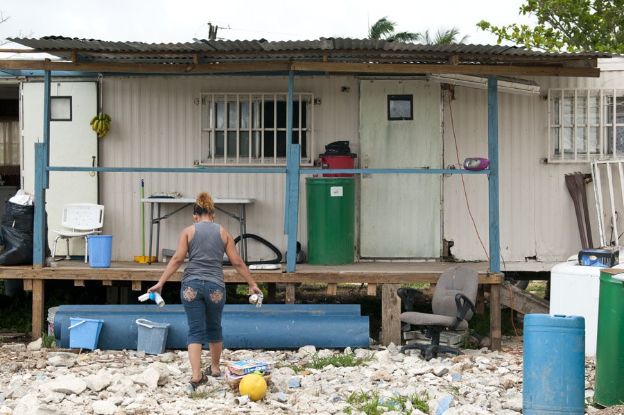 Residents clear land in the terreno in Toa Baja, Puerto Rico. Many homes on the land are hollowed-out trailers that residents renovate. Photo by Molly J. Smith
