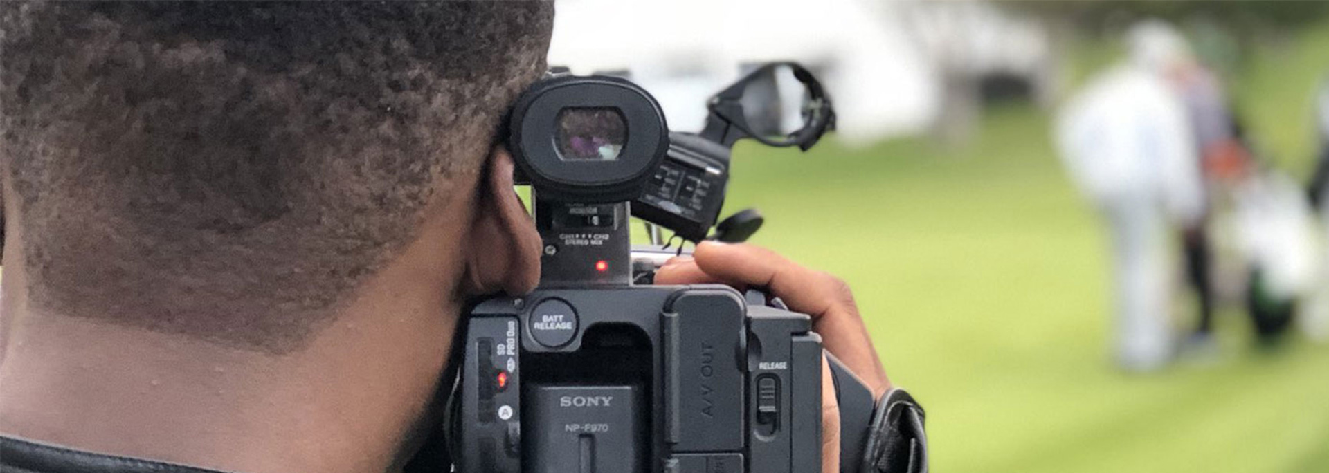 A student holds a broadcast camera.