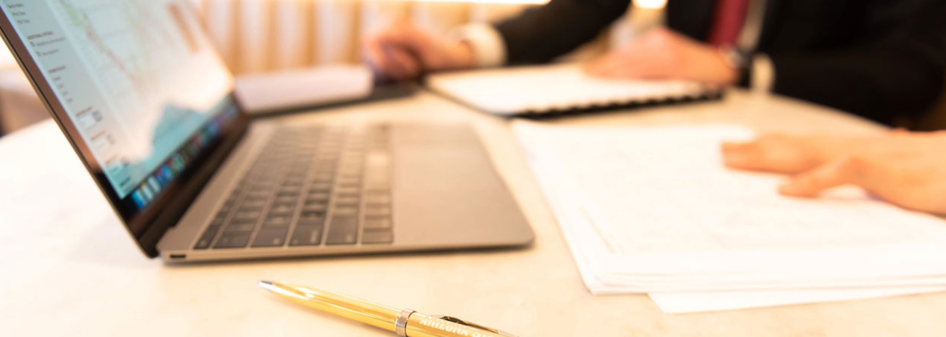 A computer open on a desk.