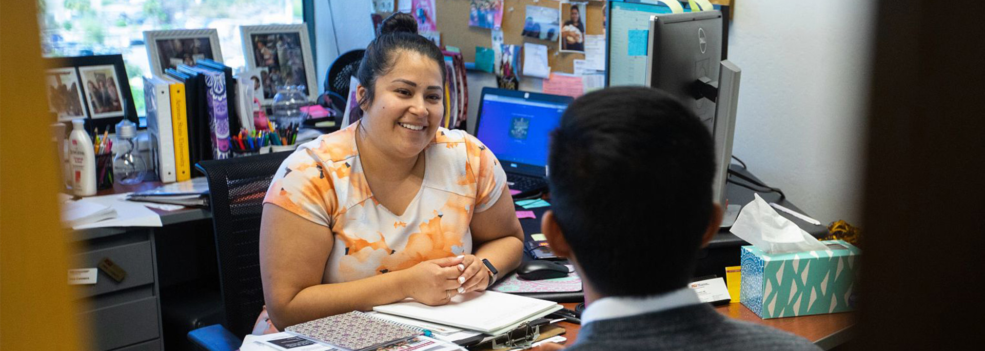 An adviser meets with a student in her office.