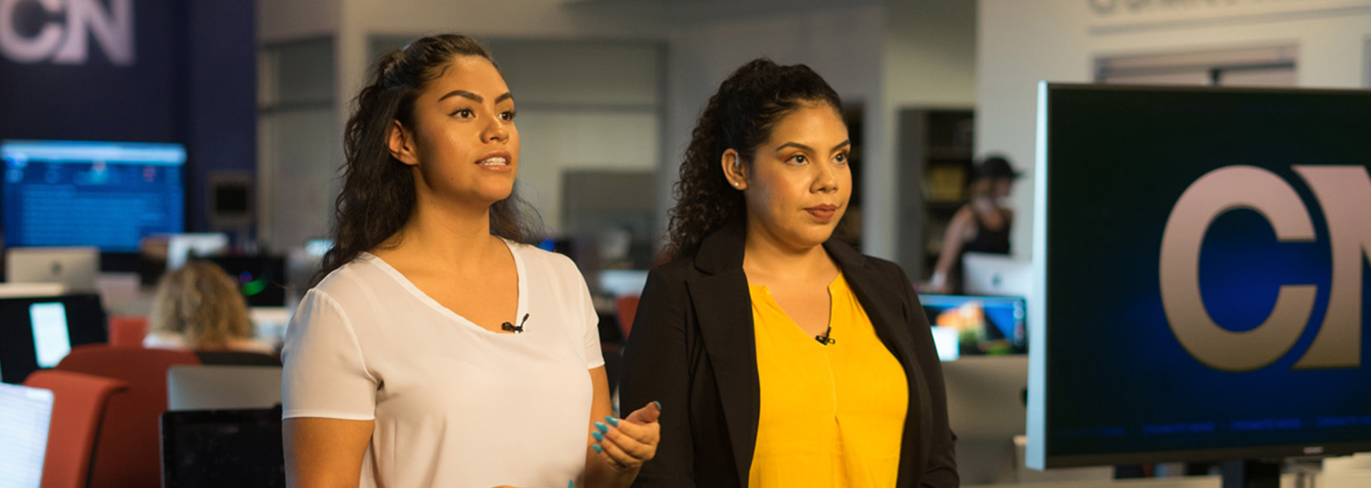 Two Cronkite Noticias students report from the newsroom.