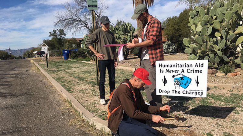 People putting up humanitarian aid sign