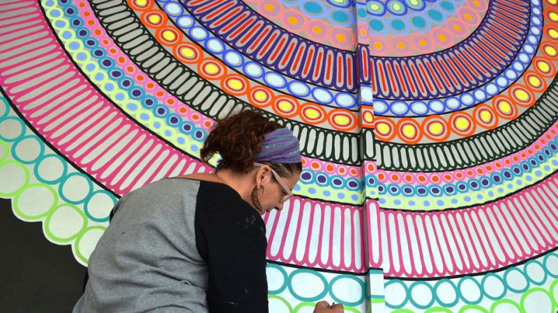 Arizona artist Kyllan Maney creating a colorful mural in downtown Phoenix