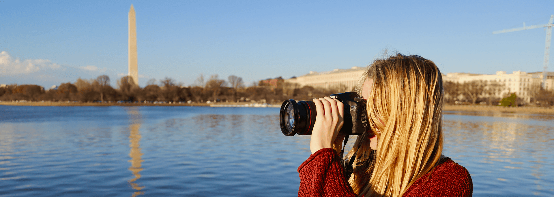 
		A student photographer takes a picture in front of the Washington Monument.		