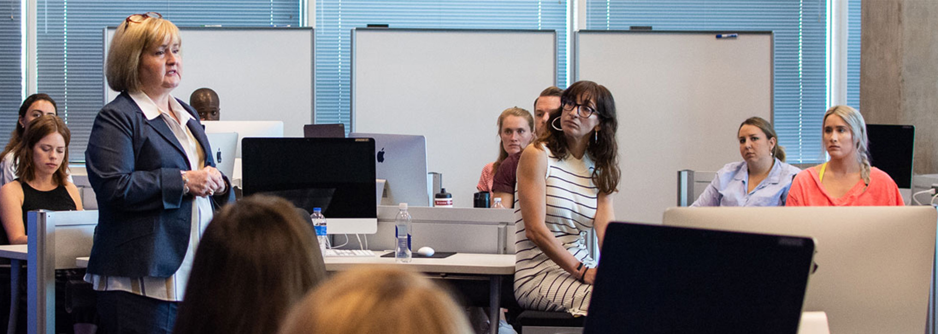A professor lecturing to a classroom.