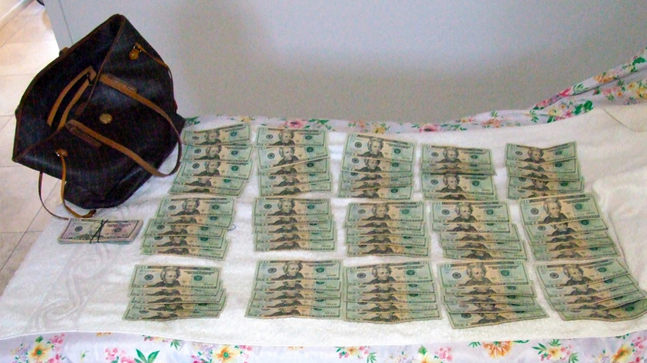 dollars lay on a tablecloth.