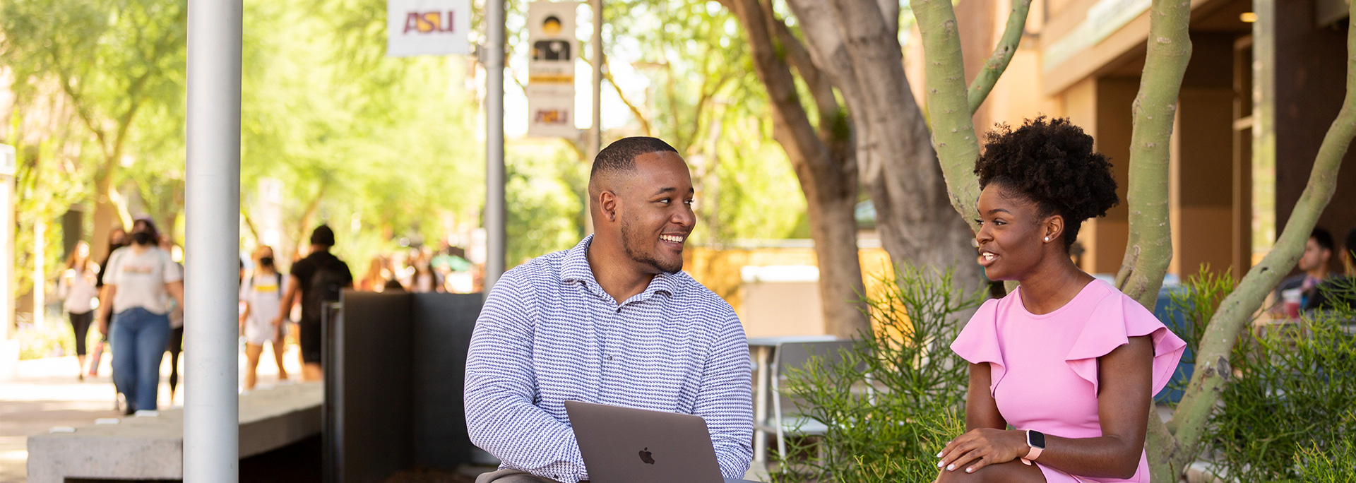 
		Two graduate students chat outdoors on the Downtown Phoenix Campus.		