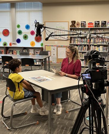 Cronkite associate professor Asheley Landrum interviews a child for a special on CNN. Photo courtesy of CNN.