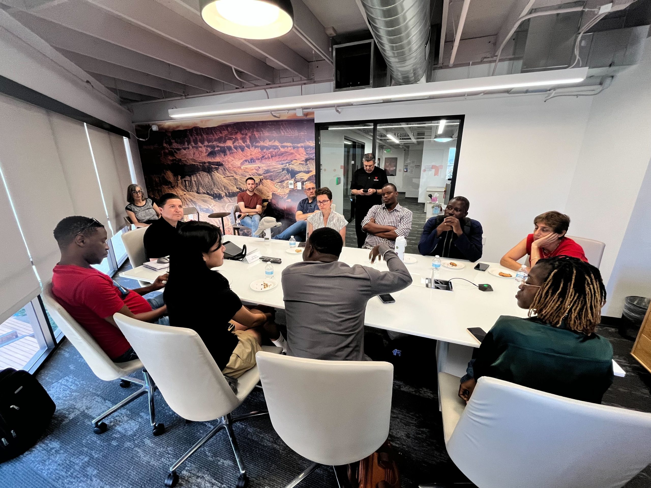 Hubert H. Humphrey fellows lead a meeting at a conference table.