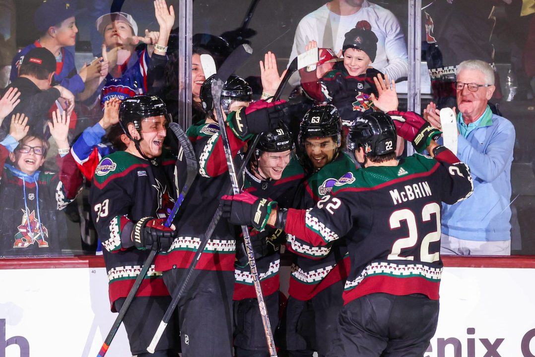 Arizona Coyotes right wing forward Josh Doan (91) celebrates scoring his first NHL goal with his teammate at Mullett Arena in Tempe, Ariz. on Tuesday, March 26, 2024. (Photo by Reece Andrews)