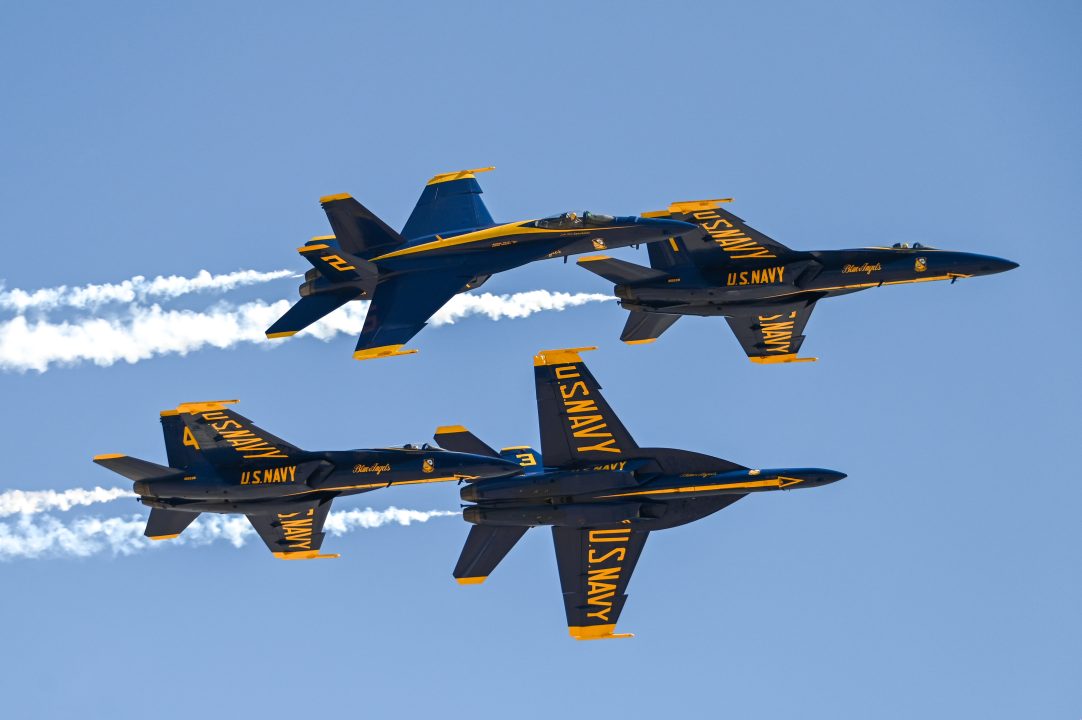 Four Naval planes flying in formation.