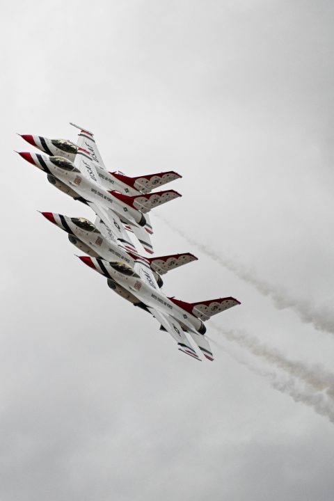 Planes fly in formation.