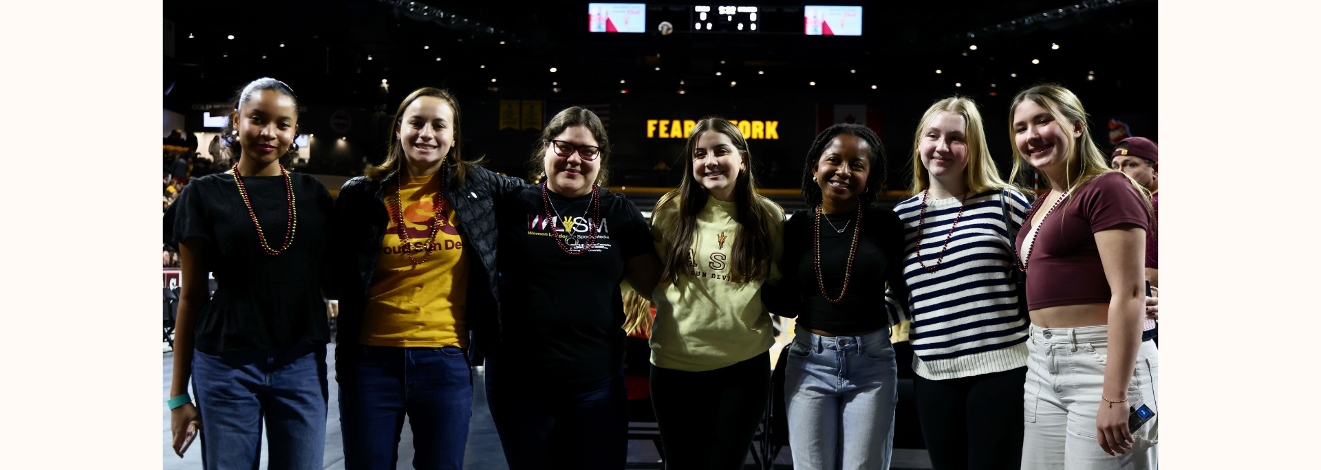 
		WLSM members stand in front of an ASU women's volleyball match.		