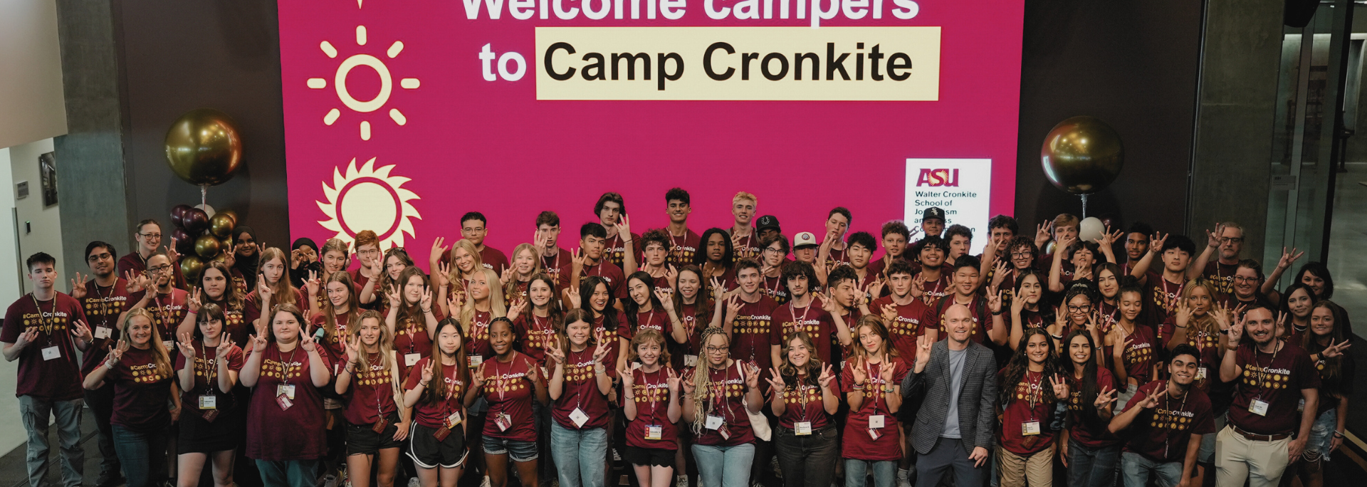 
		Dozens of Camp Cronkite campers hold a 