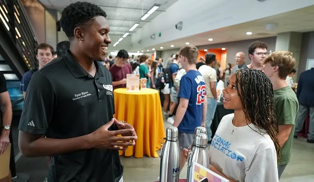 Two students converse at Cronkite Nation Night in the First Amendment Forum